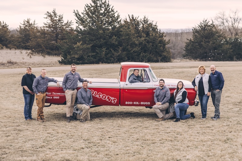 Team in front of truck