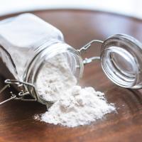 Borax Powder Spilling from a Glass Container on Wooden Table
